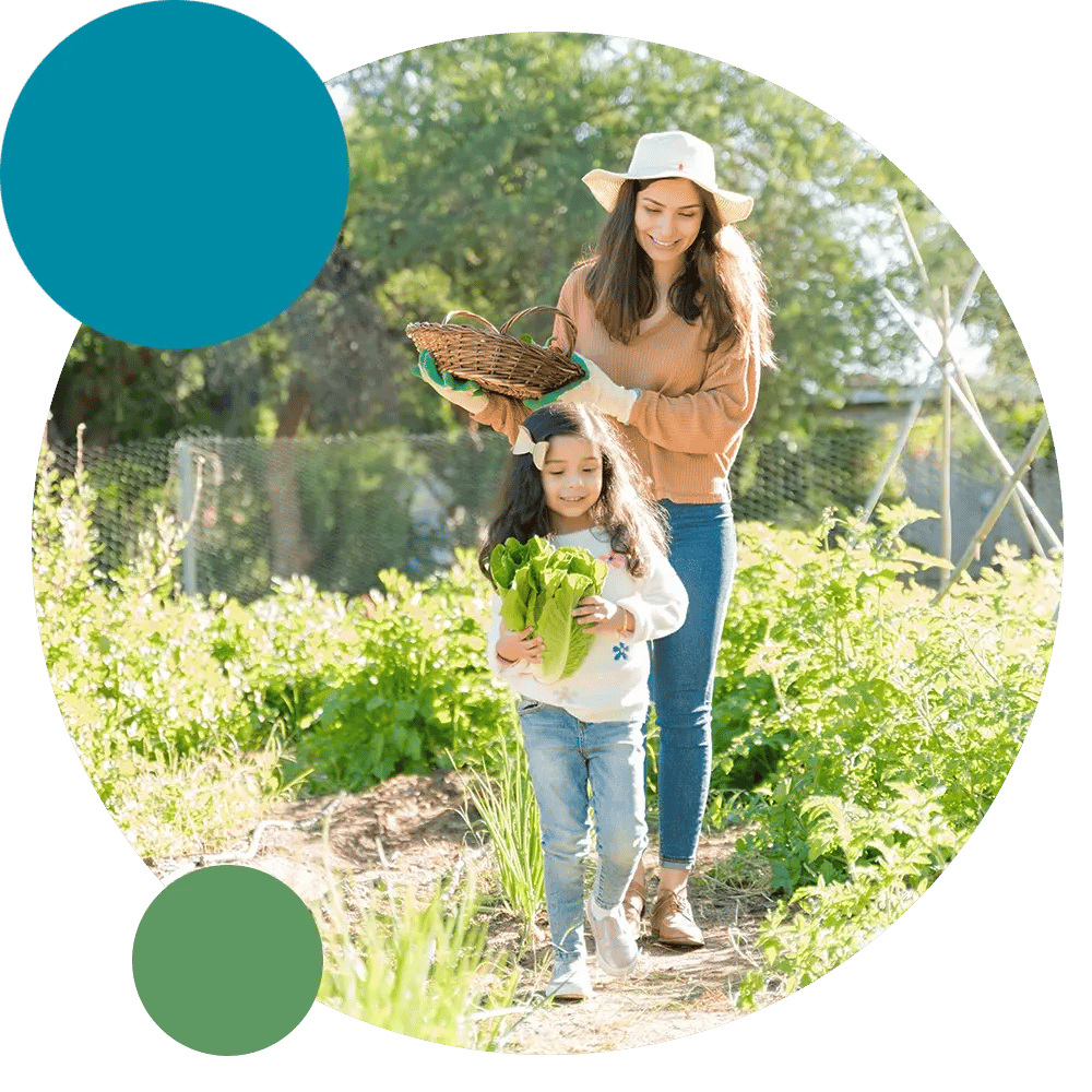 Mother and child picking up vegetables